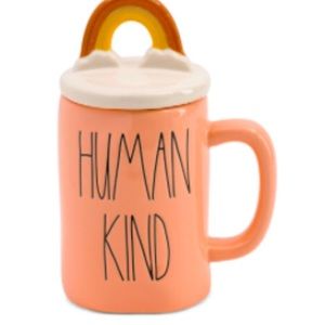 Rae Dunn human kind coffee mug with Rainbow topper.